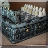 D04. Carved stone miniature chess set. 